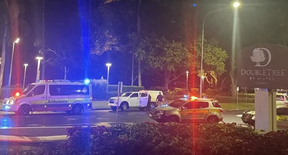 Rescue workers outside the Double Tree Hotel by Hilton in Cairns after a helicopter crashed into it. 