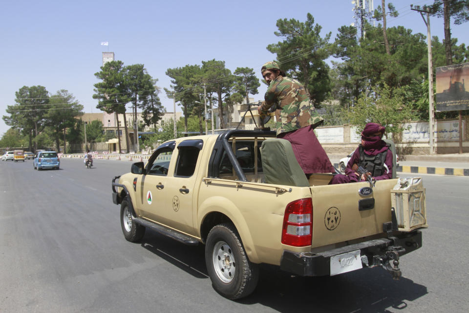 Taliban fighters sit on the back of a vehicle in the city of Herat, west of Kabul, Afghanistan, Saturday, Aug. 14, 2021, after they took this province from Afghan government. The Taliban seized two more provinces and approached the outskirts of Afghanistan’s capital. (AP Photo/Hamed Sarfarazi)