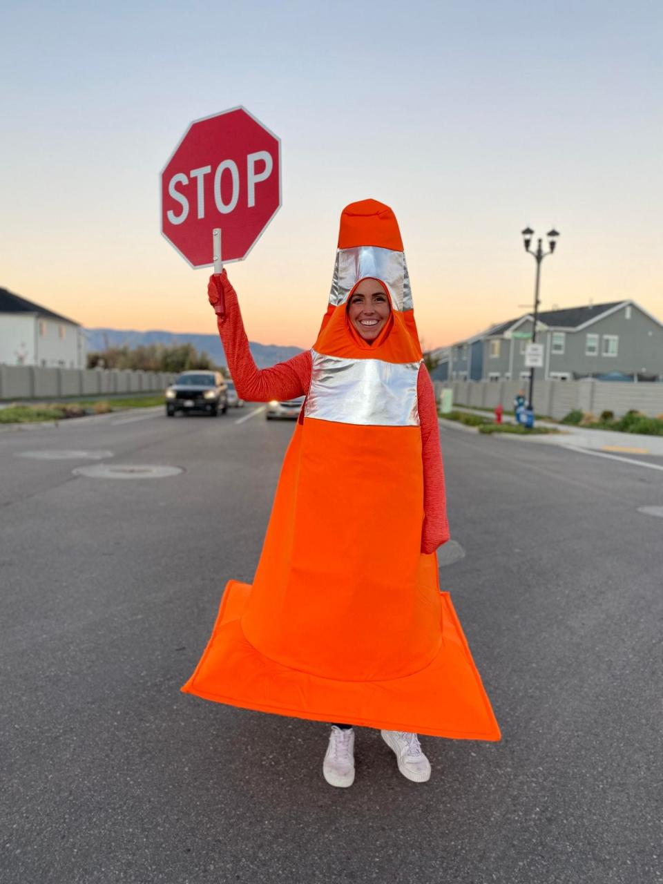 Whitney Durfee dresses up as traffic cone to raise awareness about safety at crosswalks.