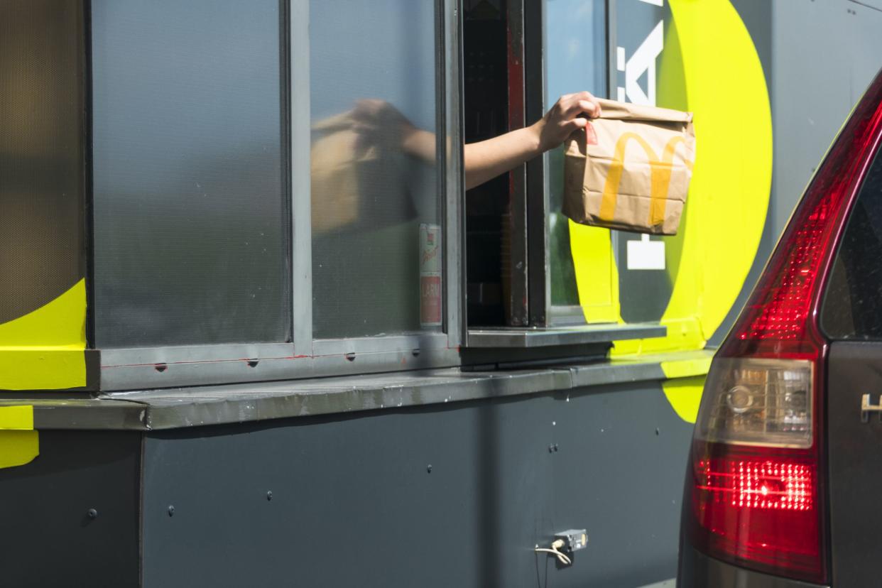 Stockholm, Sweden An attendant hands over food at a  Mc Donald's drive-thru window.