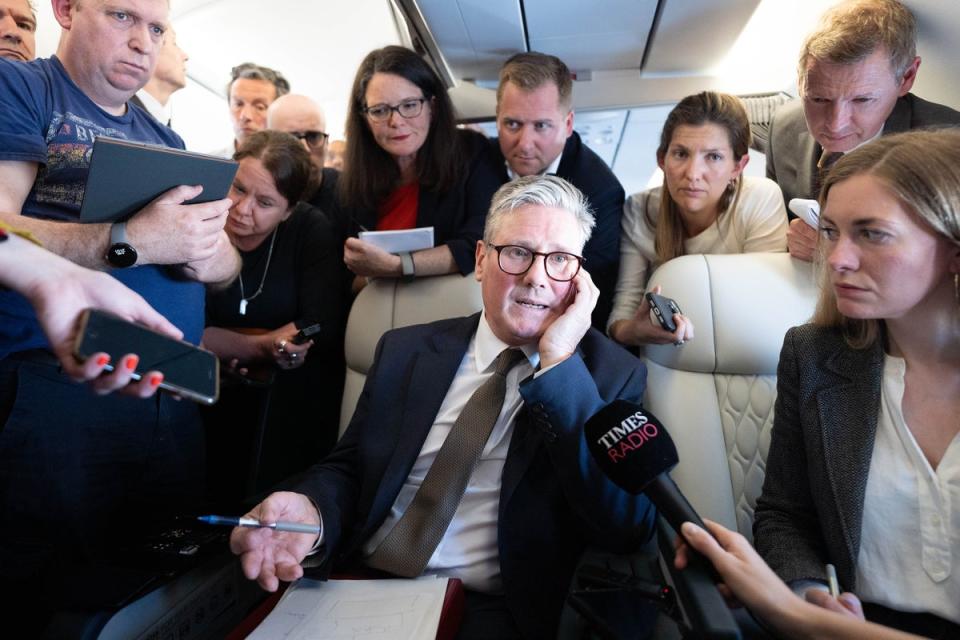 Sir Keir Starmer talks to journalists as he travels on board a plane to Washington (PA Wire)