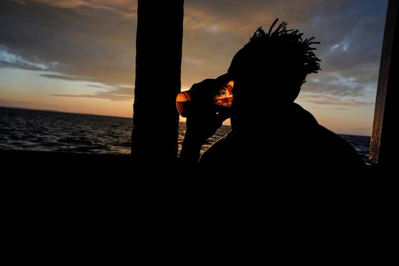 Migrant drinks a tea on board of NGO Proactiva Open Arms rescue boat in the central Mediterranean Sea at the Italian port of Taranto