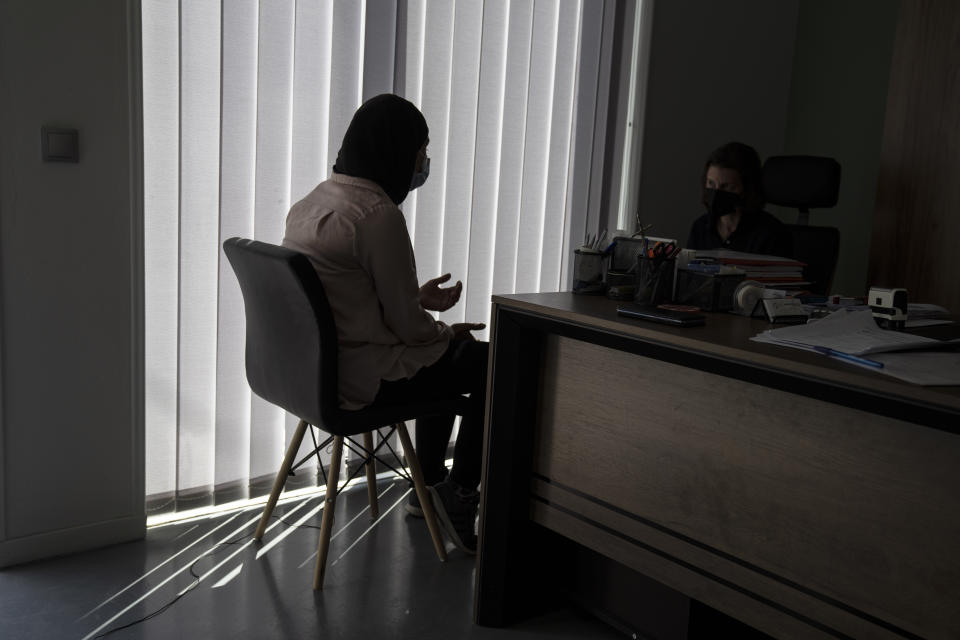 Huda Zaga, a Palestinian woman, speaks during an interview with The Associated Press, in Samos island, Greece, Wednesday, June 9, 2021. The woman and her three children apparently eluded Greek authorities after reaching Samos in April with nearly three dozen other migrants, who were returned to Turkey. The Zuga family applied for and were granted asylum, adding credence to allegations that summary deportations, known as pushbacks, are occurring, despite Greece’s denials. (AP Photo/Petros Giannakouris)