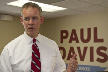 Kansas House Minority Leader and the Democratic candidate for Governor Paul Davis makes a point as he talks with his workers at his campaign headquarters in Lawrence Kansas July 24, 2014. REUTERS/Dave Kaup