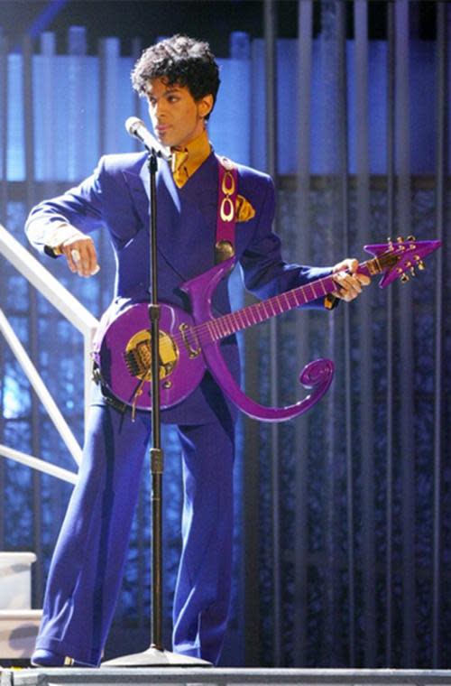 Please tell us who looks better in a purple zoot suit than Prince. Especially while playing his matching, custom guitar shaped like the “Love Symbol,” which he took as his moniker from 1993 to 2000. Please!