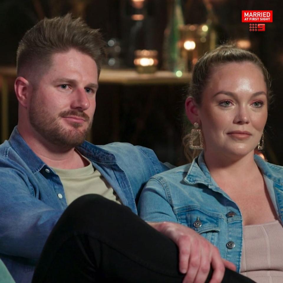 MAFS' Melissa Rawson and Bryce Ruthven sit next to one another on the couch during a commitment ceremony