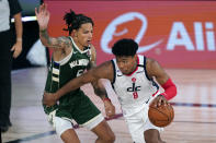 Washington Wizards' Rui Hachimura (8) drives past Milwaukee Bucks' D.J. Wilson, left, during the first half of an NBA basketball game, Tuesday, Aug. 11, 2020, in Lake Buena Vista, Fla. (AP Photo/Ashley Landis, Pool)