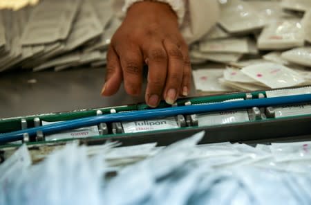 An employee works on condoms in a factory in Buenos Aires