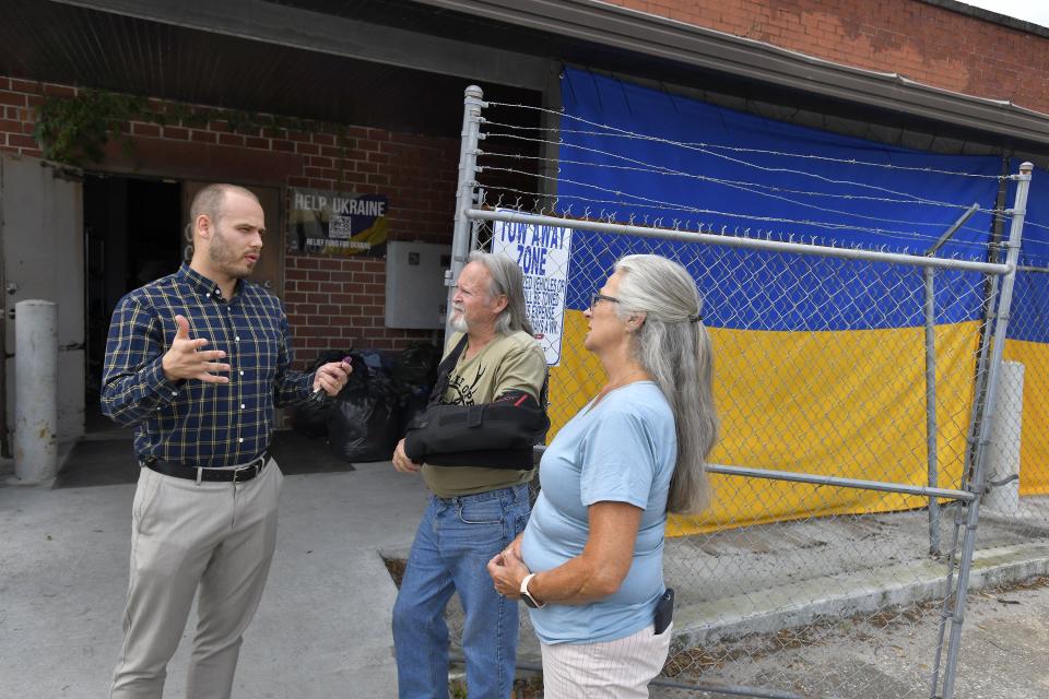 Ilya Soroka talks with Ruth and Joe Barber about what they can do to help local Ukrainian refugees after the Barbers dropped off fresh eggs from their own chickens at a warehouse loaded with supplies. Some supplies are bound for Ukraine while others will help new refugees and those expected in the coming weeks.