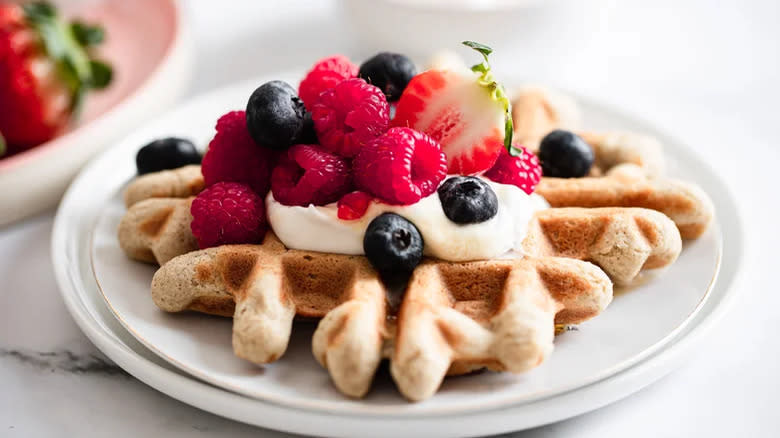 Waffles with fresh fruit and yogurt or cream