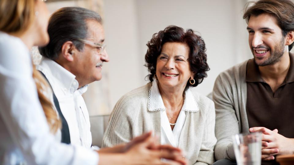 Senior adults talking with their adult children.