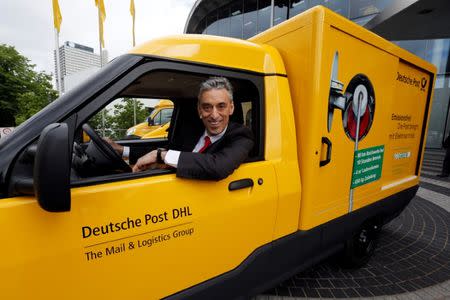 Frank Appel, CEO of German postal and logistics group Deutsche Post DHL looks out of a StreetScooter E-car in Bonn May 21, 2013. REUTERS/Wolfgang Rattay /File Photo