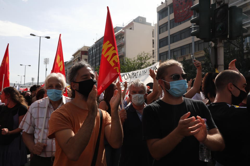 Anti-fascist protesters applaud as they celebrate following the announcement of the court verdict, outside the courthouse in Athens, Wednesday, Oct. 7, 2020. The court ruled that the far-right Golden Dawn party was operating as a criminal organization, delivering a landmark guilty verdict in a marathon five-year trial.The court ruled seven of the party's former lawmakers, including party leader Nikos Michaloliakos, were guilty of leading a criminal organization, while the others were guilty of participating in a criminal organization. (AP Photo/Yorgos Karahalis)