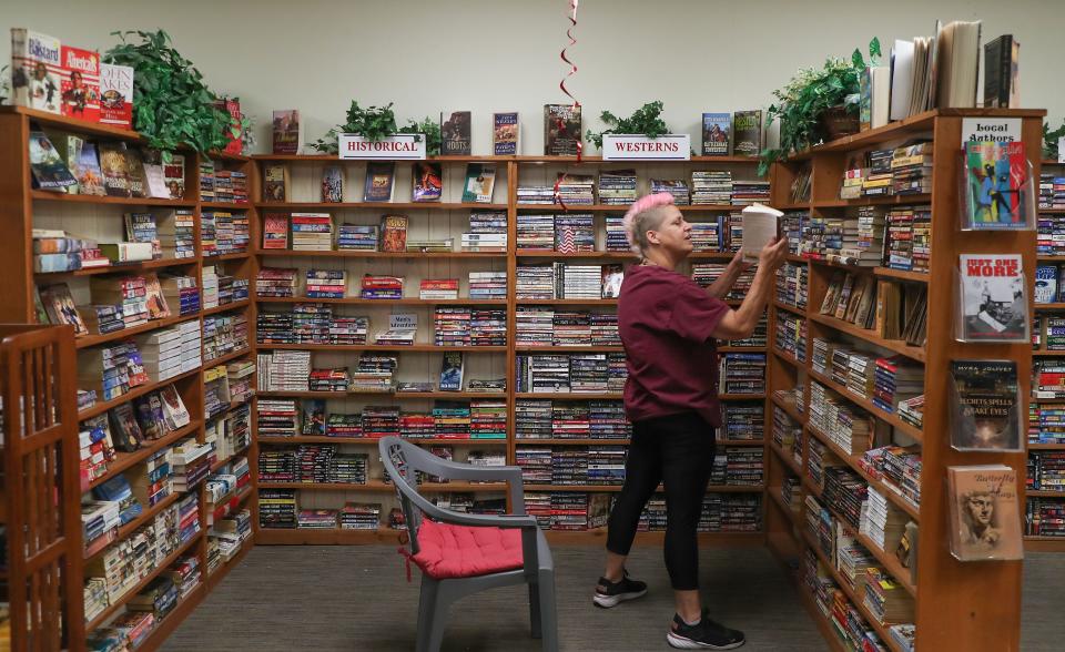 Tracy Blackburn works at The Book Rack used book store in La Quinta, Calif., June 16, 2022.