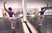 Ballet student Micah Sparrow stretches in a classroom at the Texas Ballet Theatre, Wednesday, Oct. 7, 2020, in Fort Worth, Texas. For many, it's not Christmas without the dance of Clara, Uncle Drosselmeyer, the Sugar Plum Fairy, the Mouse King and, of course, the Nutcracker Prince. But this year the coronavirus pandemic has canceled performances of “The Nutcracker” around the U.S. and Canada, eliminating a major and reliable source of revenue for dance companies already reeling financially following the essential shutdown of their industry. (AP Photo/LM Otero)