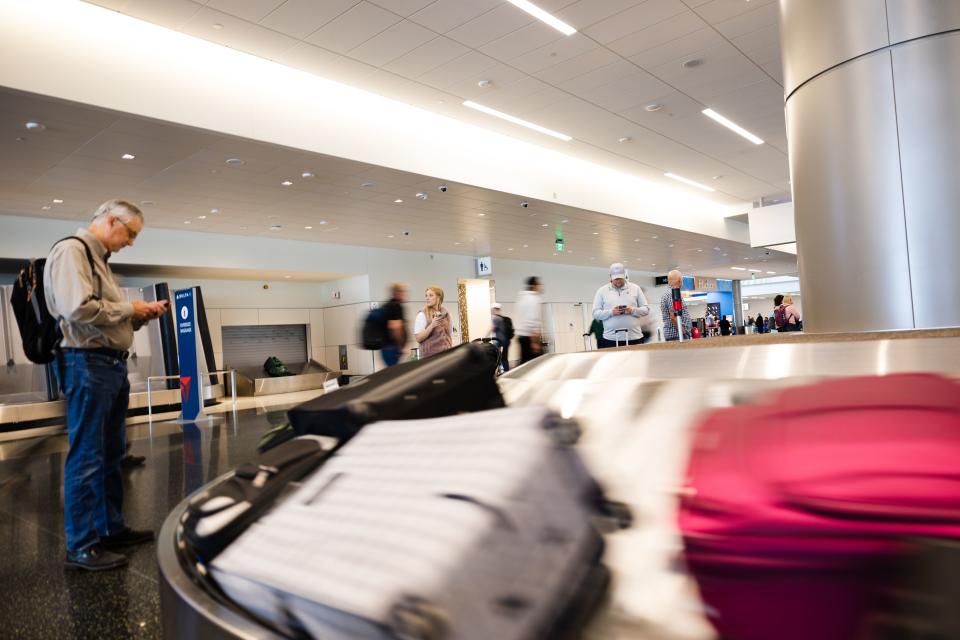 Travelers wait to pick up their luggage at the Salt Lake City International Airport in Salt Lake City on Friday, May 19, 2023. | Ryan Sun, Deseret News