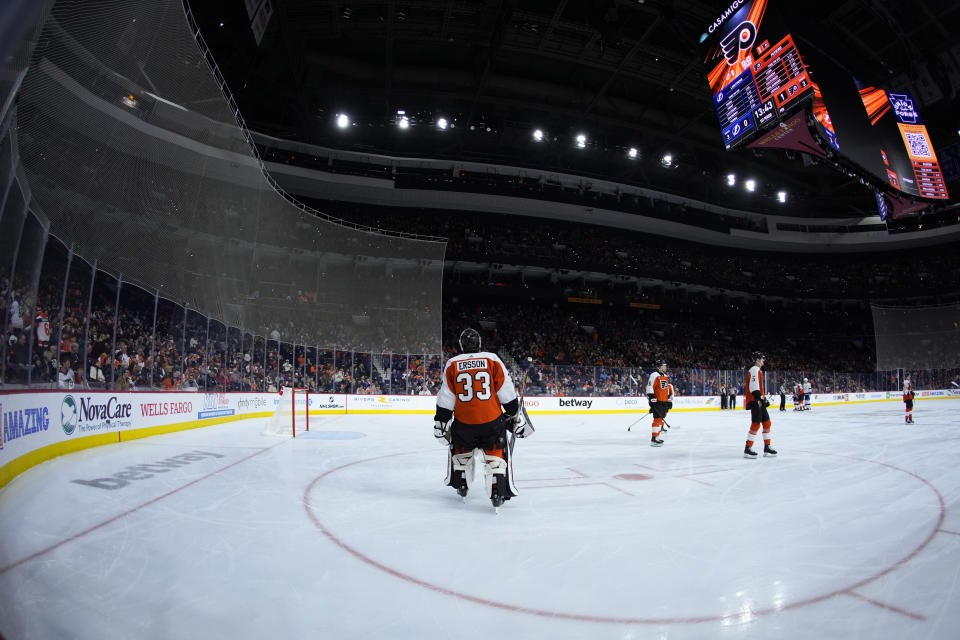 Philadelphia Flyers' Samuel Ersson skates on the ice during a partial power outage in the first period of an NHL hockey game against the Tampa Bay Lightning, Tuesday, Feb. 27, 2024, in Philadelphia. (AP Photo/Matt Slocum)