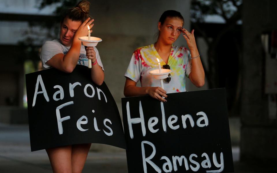 Students held a candlelit vigil for the victims of the shooting - REUTERS