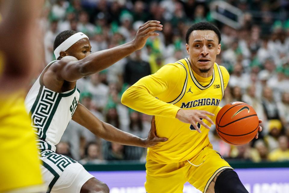 Michigan guard Jaelin Llewellyn (3) dribbles against Michigan State guard Tre Holloman (5) during the first half at Breslin Center in East Lansing on Tuesday, Jan. 30, 2024.