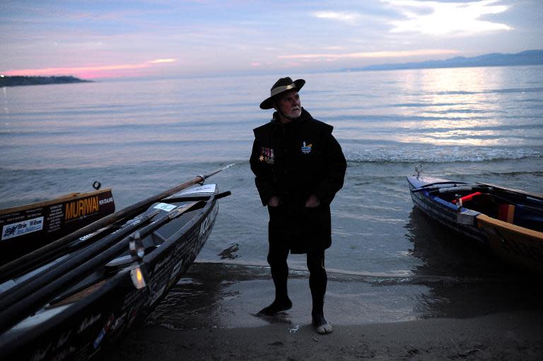 An Australian man stands next to boats on Hamza koy beach in the town of Gallipoli, during an unofficial dawn service marking the 100th anniversary of Anzac Day, on April 25, 2015