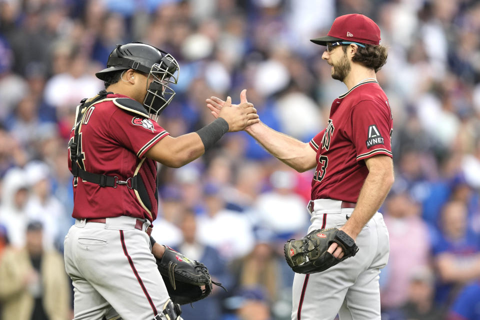 Arizona Diamondbacks catcher Gabriel Moreno, left, and starting pitcher Zac Gallen, right, celebrate after Galen's complete game shutout of the Chicago Cubs in a baseball game Friday, Sept. 8, 2023, in Chicago. (AP Photo/Charles Rex Arbogast)