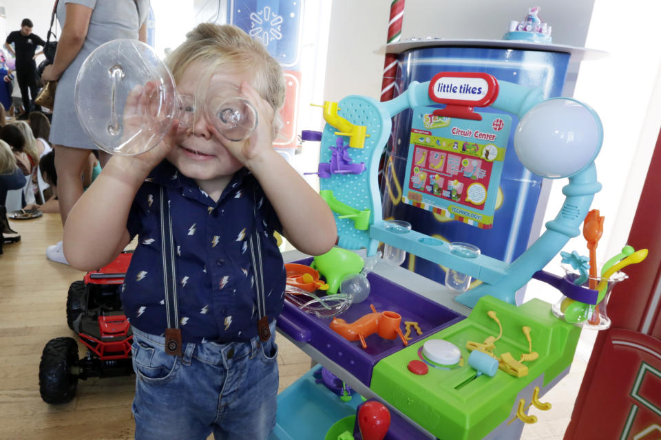 In this Aug. 30, 2018, photo Hutton, 3, plays with Little Tikes Circuit Center at the Walmart Toy Shop event in New York. Walmart says 30 percent of its holiday toy assortment will be new. It will also offer 40 percent more toys on Walmart.com from a year ago. In November and December, the company’s toy area will be rebranded as “America’s Best Toy Shop.” (AP Photo/Richard Drew)