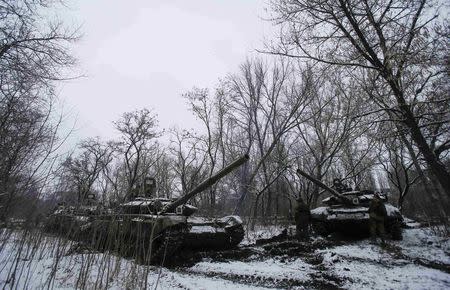 Pro-Russian separatists stand next to tanks on the outskirts of Horlivka, eastern Ukraine February 10, 2015. REUTERS/Maxim Shemetov
