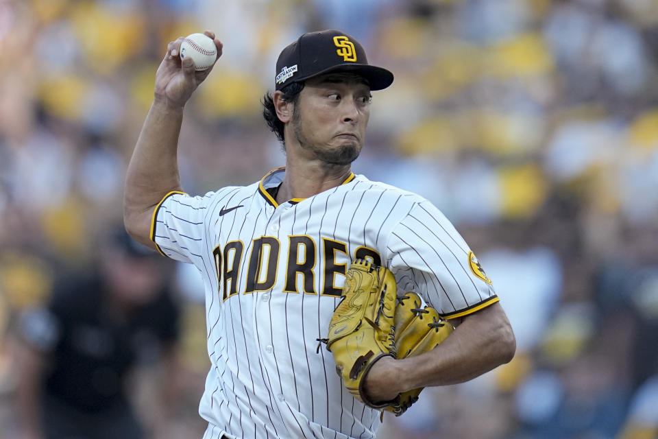 FILE - San Diego Padres starting pitcher Yu Darvish throws against the Philadelphia Phillies during the first inning in Game 1 of the baseball NL Championship Series between the San Diego Padres and the Philadelphia Phillies, Oct. 18, 2022, in San Diego. Darvish has agreed to a new contract with the San Diego Padres that guarantees the pitcher an additional $90 million and will keep him with the club through the 2028 season, a person with direct knowledge of the deal said Thursday, Feb. 9, 2023. (AP Photo/Gregory Bull, File)