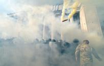 Smoke rises from the parliament building in Kiev as activists from radical Ukrainian parties, including the nationalist party Svoboda (Freedom), clash with police officers on August 31, 2015