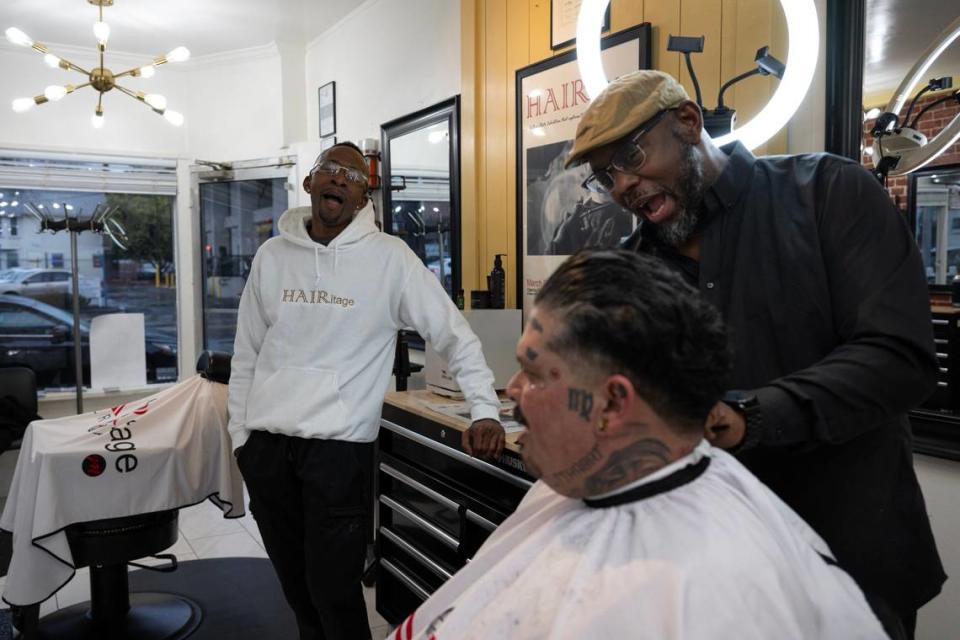 Marichal Brown, right, talks with customer Joe Chavarria with his brother Rodney Brown, left, at HAIRitage Salon on Feb. 29. They are part of a growing national network of Black barbers and stylists who have become frontline mental health advocates in their communities as part of the Confess Project. Paul Kitagaki Jr./pkitagaki@sacbee.com