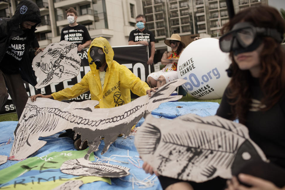 Demonstrators protest against the auction for the exploration of oil fields close to Abrolhos, a marine national park in Bahia state, in Rio de Janeiro, Brazil, Thursday, Oct. 10, 2019. Under pressure from environmental organizations, none of the 17 companies involved in the process presented any offers. (AP Photo/Silvia Izquierdo)