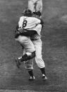 FILE - In this Oct. 8, 1956, file photo, New York Yankees catcher Yogi Berra leaps into the arms of pitcher Don Larsen after Larsen struck out the last Brooklyn Dodgers batter to complete his perfect game during Game 5 of the World Series in New York. Larsen, the journeyman pitcher who reached the heights of baseball glory in 1956 for the Yankees when he threw a perfect game and only no-hitter in World Series history, died Wednesday, Jan. 1, 2020. He was 90. (AP Photo/File)