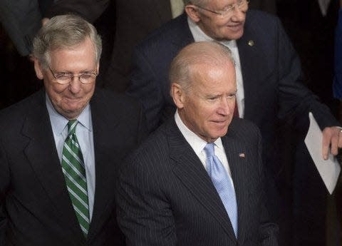 File photo of Sen. Mitch McConnell of Kentucky, left, and President Joe Biden in the Senate floor. Biden agreed to nominate the senator's choice for federal district judge in Kentucky — a candidate the Republican leader had been trying to get on the bench since 2020.