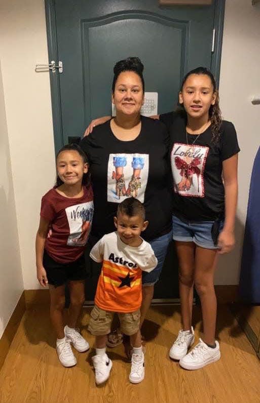 Abigale Veloz stands with her children Miah Cerrillo, right, Miguel Cerrillo Jr., bottom center, and Elena Cerrillo, left. Miguel Cerrillo Jr., 4, will attend pre-K in person this fall, despite some concerns in the wake of May's Uvalde school shooting.