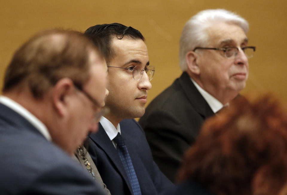 Former President Macron's security aide Alexandre Benalla, center, during the French Senate Laws Commission prior to his hearing, in Paris, Monday, Jan. 21, 2019. Benalla has been taken into police custody last week in an investigation of possible misuse of diplomatic passports and then released. (AP Photo/Christophe Ena)