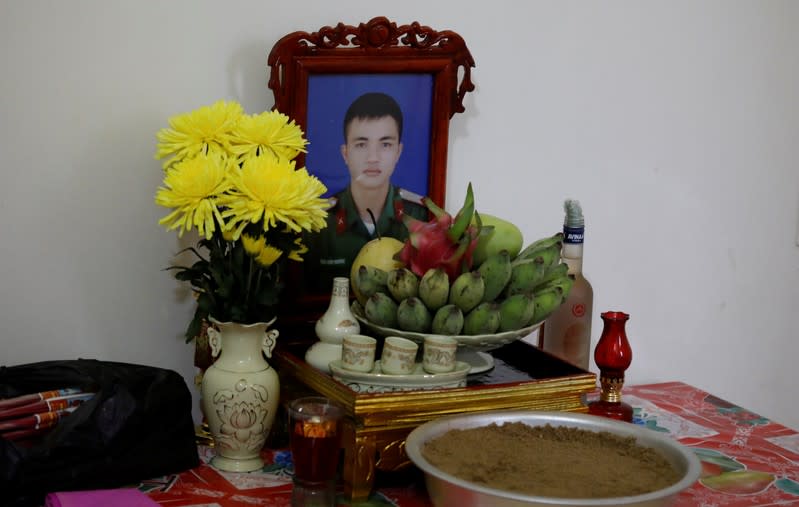 An image of Nguyen Dinh Tu, a Vietnamese suspected victim in a truck container in UK, is seen at a table at his home in Nghe An province