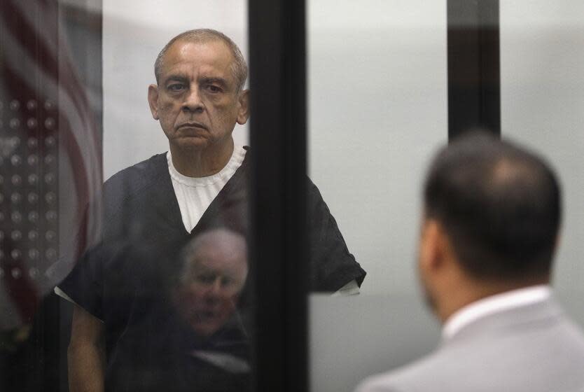 Vista, CA_4_26_24_Defendant Gary Johnson, left, seen behind plexiglass, was arraigned in the Vista Courtroom of Harry Elias(reflected at bottom) and was represented by attorney Peter Blair, at right. Photo by John Gastaldo for the Union-Tribune