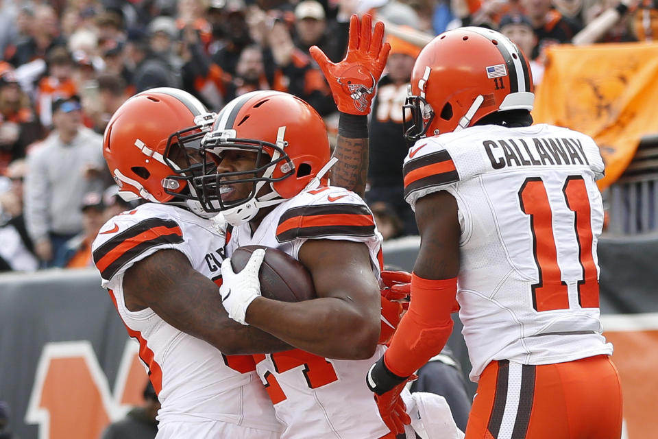 Cleveland Browns running back Nick Chubb, center, celebrates his touchdown with wide receivers Antonio Callaway (11) and Jarvis Landry, left, in the first half of an NFL football game against the Cincinnati Bengals, Sunday, Nov. 25, 2018, in Cincinnati. (AP Photo/Frank Victores)