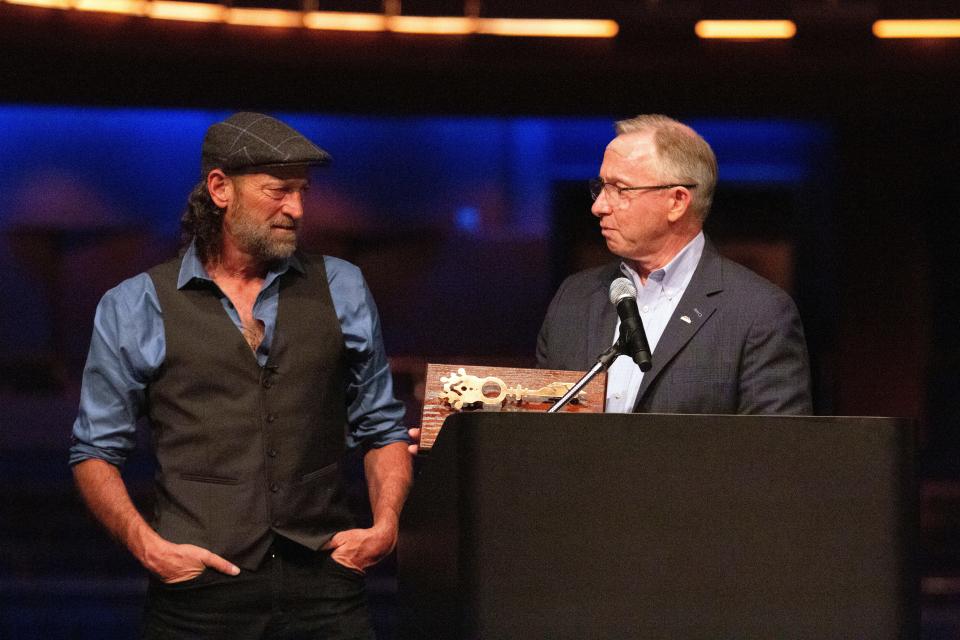 Actor Troy Kotsur (left) receives the key to the city from Mesa Mayor John Giles on Aug. 11, 2022, in Mesa. Kotsur, who made history as the first deaf man to win an Academy Award, has been honored with a key to his Arizona hometown.