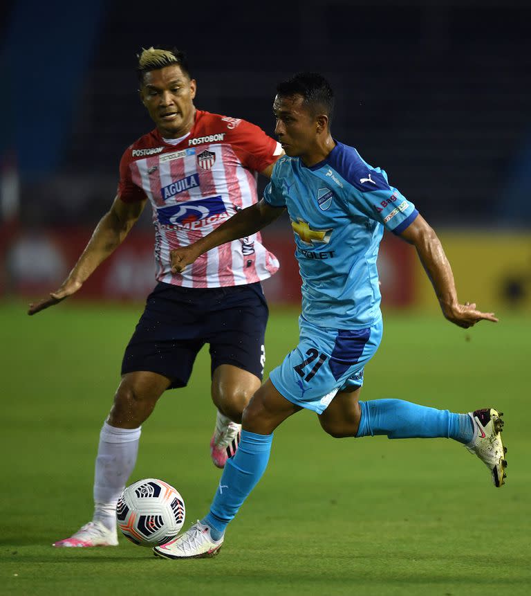 Teófilo Gutierrez ante Roberto Carlos Fernandez. (Photo by JUAN BARRETO / AFP)