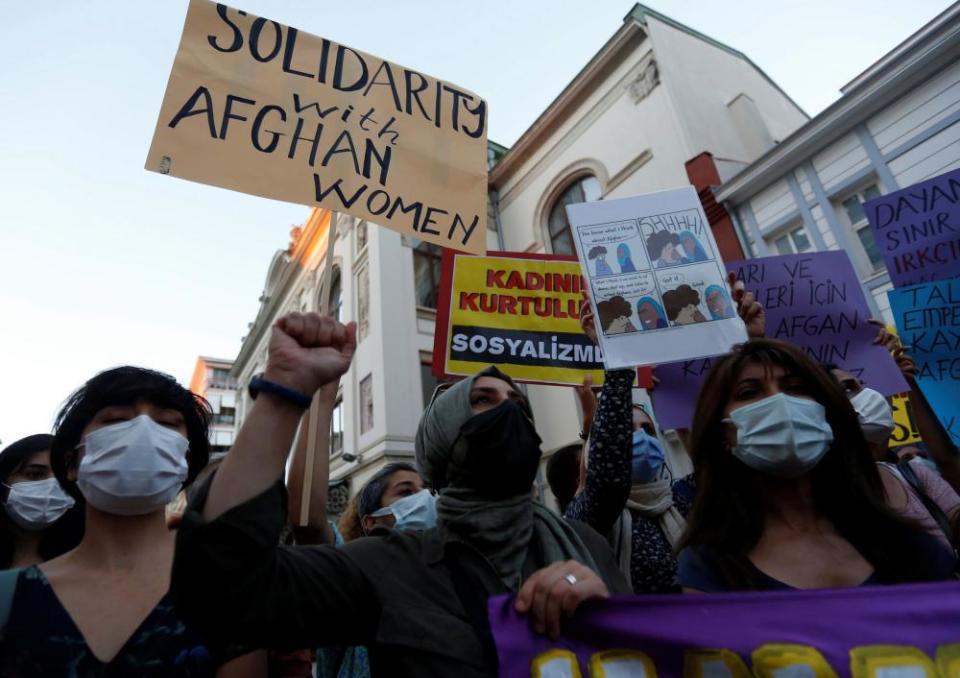 Activists hold signs in support of Afghan women during a demonstration in Istanbul, Turkey.