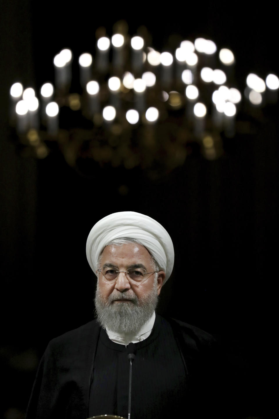 Iranian President Hassan Rouhani listens during a joint press conference with Japanese Prime Minister Shinzo Abe, after their meeting at the Saadabad Palace in Tehran, Iran, Wednesday, June 12, 2019. The Japanese leader is in Tehran on an mission to calm tensions between the U.S. and Iran. (AP Photo/Ebrahim Noroozi)