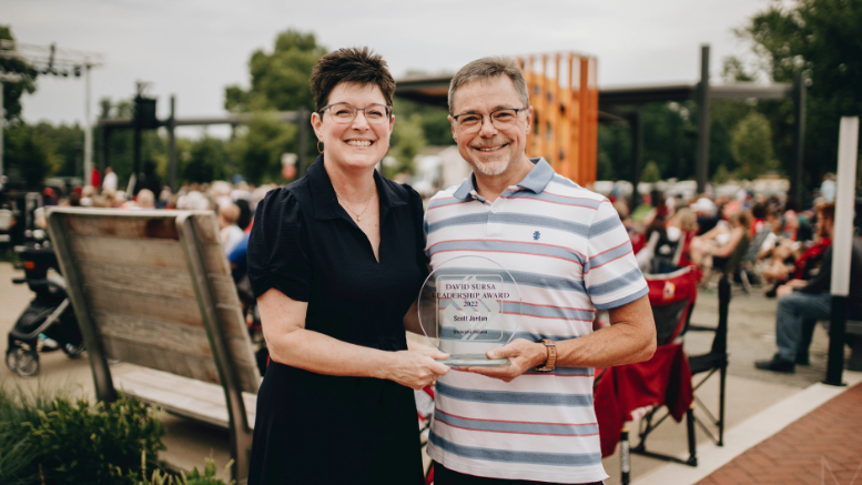 Community Foundation of Muncie and Delaware County President Kelly K. Shrock presents the 2022 David Sursa Leadership Award to Scott Jordan for his service to Orchestra Indiana. Jordan was surprised with the award during the Patriotic Pops Concert on July 4 last year at the Yorktown Civic Green.