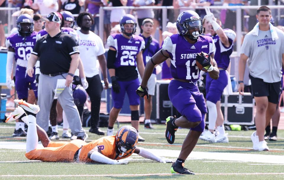 Stonehill's Jarel Washington scores a touchdown past Post University defender Jermaine Tillery during a game on Saturday, Sept. 10, 2022. 