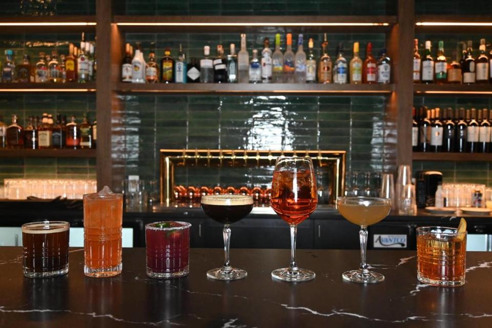 The Club House in Charlotte includes a cocktail menu with classics like Old Fashioned and Negroni and specialties such as Purple Rain made with gin, St. Germain and lavender syrup, and Queen Spritz made with aperol, mixed bitters and prosecco.