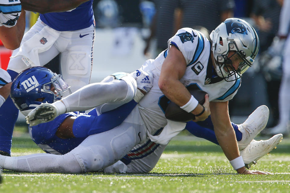 New York Giants' Julian Love, left, sacks Carolina Panthers quarterback Baker Mayfield during the second half an NFL football game, Sunday, Sept. 18, 2022, in East Rutherford, N.J. (AP Photo/John Munson)