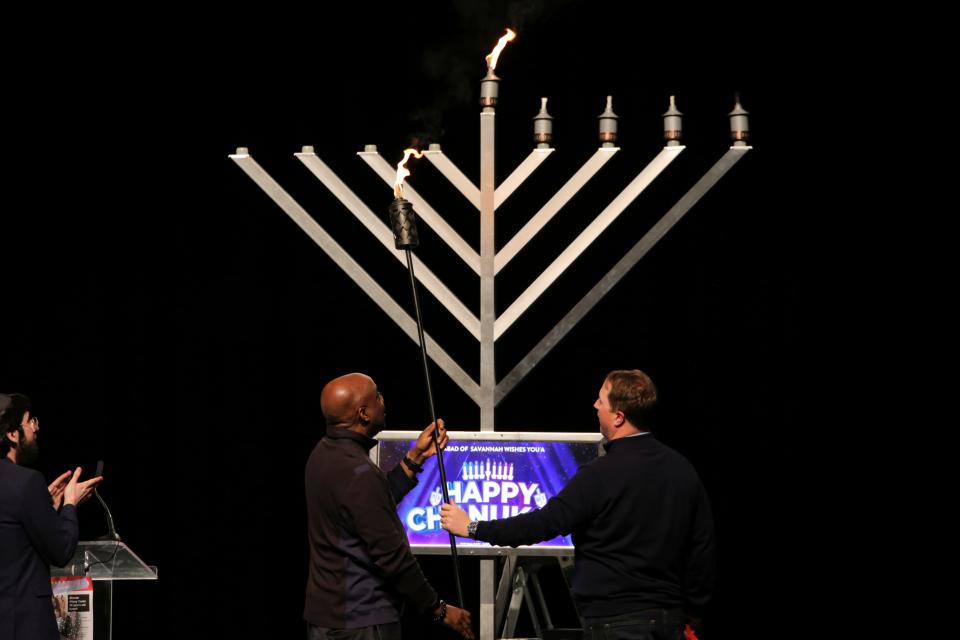 Savannah Mayor Van Johnson and City Manager Jay Melder light the Shamash candle on the menorah during the Hanukkah celebrations at the Savannah Civic Center on Sunday, December 10th, 2023.