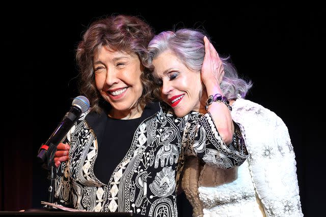 <p>Amy Sussman/Getty Images</p> Lily Tomlin and Jane Fonda speak on stage during Era Coalition Forward Women's Equality Trailblazer Awards and premiere of "Still Working 9 to 5"