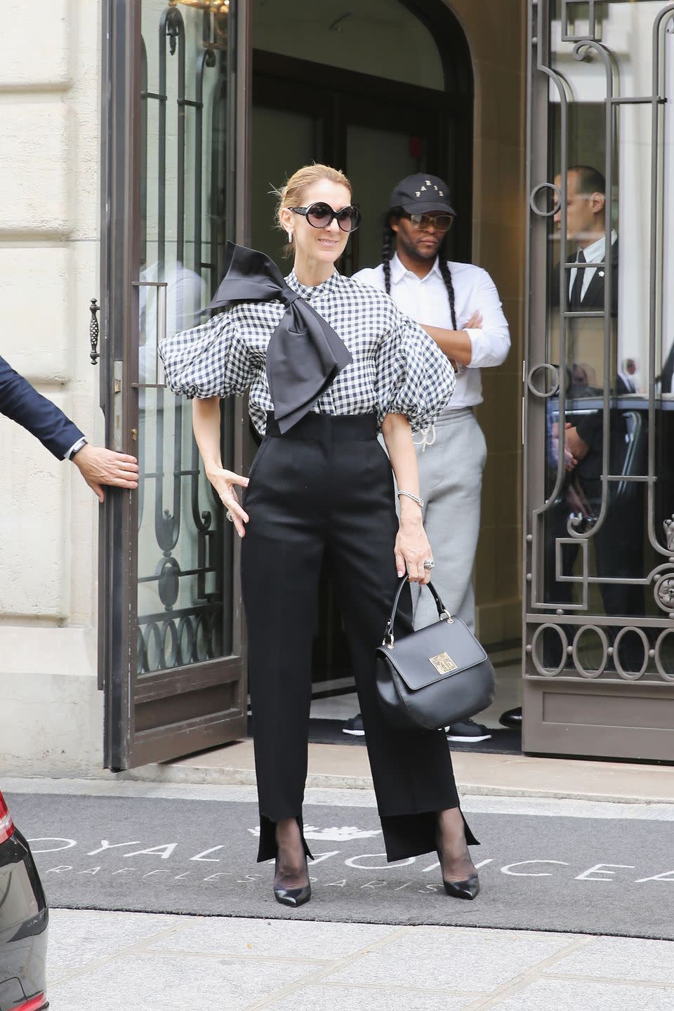 <p>In high-waisted Celine trousers, a Dice Kayek blouse detailed with a giant bow, Tom Ford heels, and a bag from her own collection while out in Paris. </p>