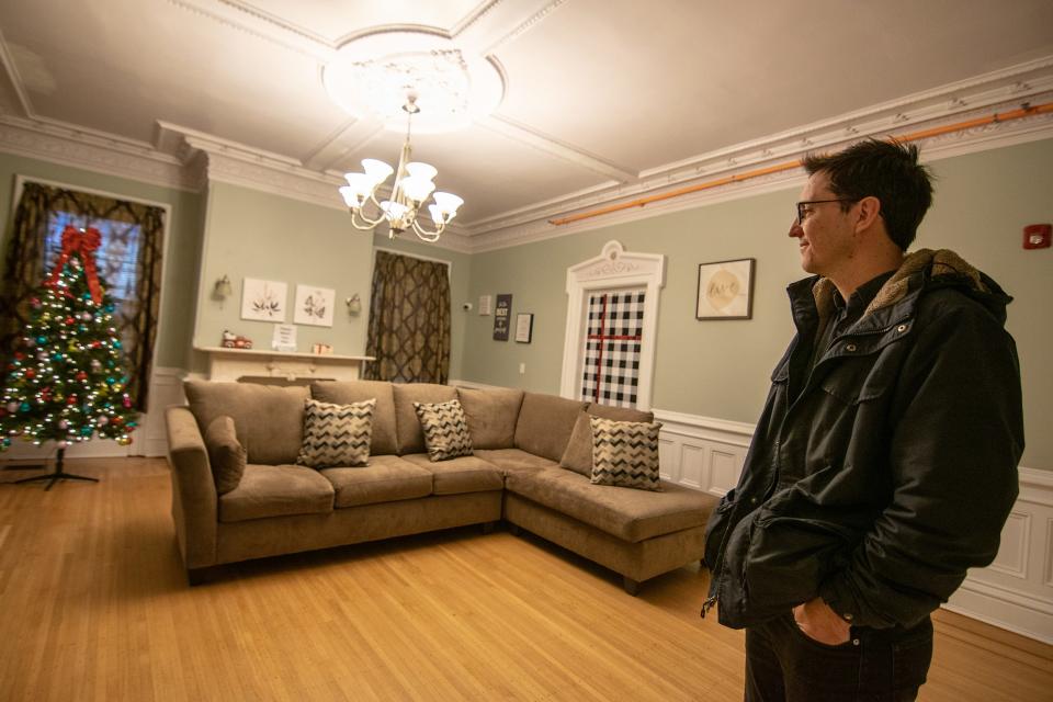 OpenDoors Co-Executive Director Nick Horton stands in the living room of his group's new shelter on Elmwood Avenue in December.